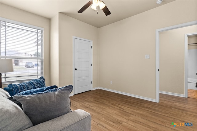 living area featuring light hardwood / wood-style flooring and ceiling fan