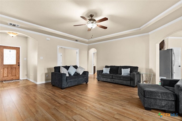 living room with crown molding, hardwood / wood-style floors, and ceiling fan