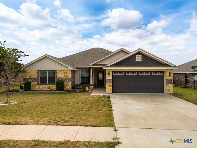 craftsman-style home featuring a front yard and a garage