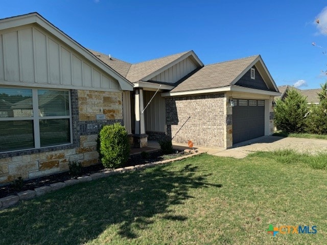 view of front of property with a garage and a front lawn