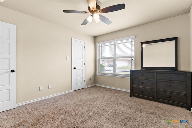 unfurnished bedroom featuring light colored carpet and ceiling fan