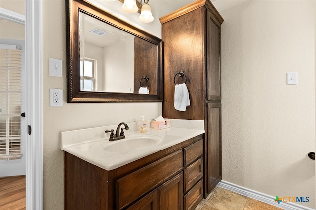 bathroom with hardwood / wood-style floors and vanity