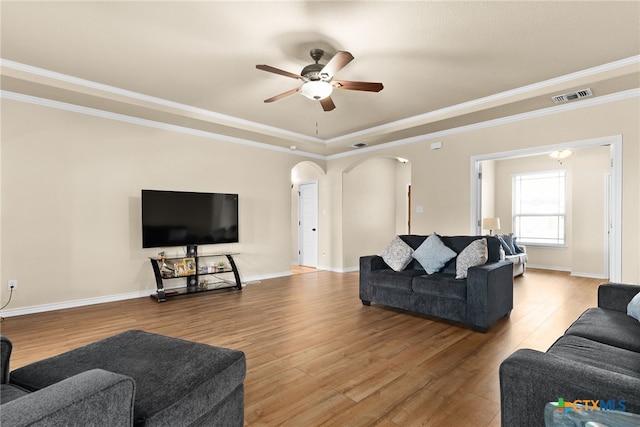 living room featuring hardwood / wood-style flooring, ceiling fan, and ornamental molding