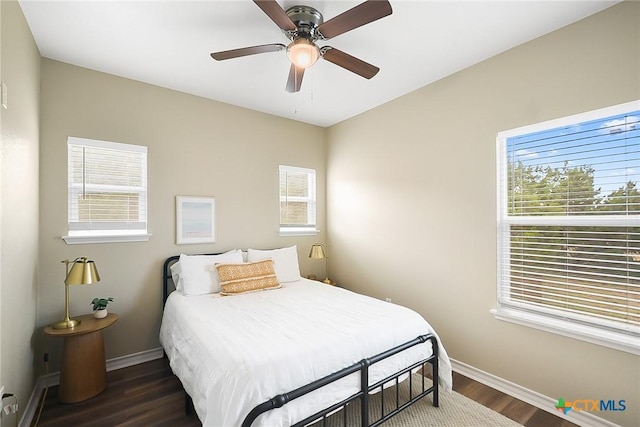 144 Slocum Dr, Canyon Lake, TX 78133 - bedroom featuring baseboards, multiple windows, dark wood finished floors, and a ceiling fan