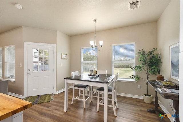 144 Slocum Dr, Canyon Lake, TX 78133 - dining room featuring dark wood-style flooring, baseboards, and a chandelier