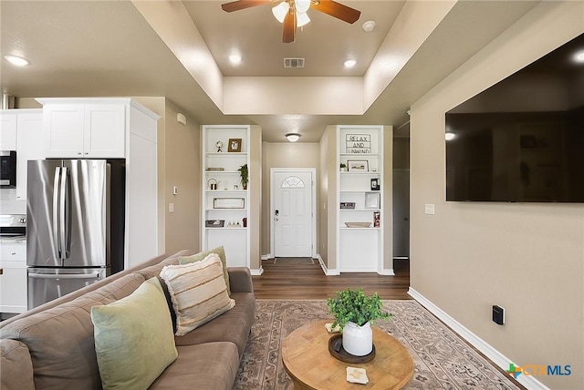 144 Slocum Dr, Canyon Lake, TX 78133 - living room with a ceiling fan, dark wood-style flooring, baseboards, a tray ceiling, and recessed lighting