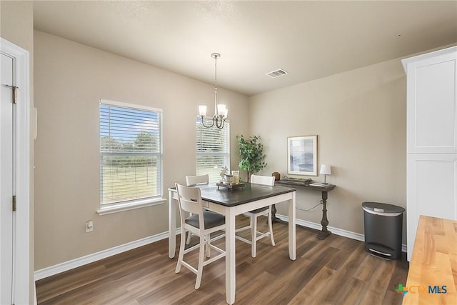 144 Slocum Dr, Canyon Lake, TX 78133 - dining room featuring dark wood-type flooring, baseboards, and a chandelier