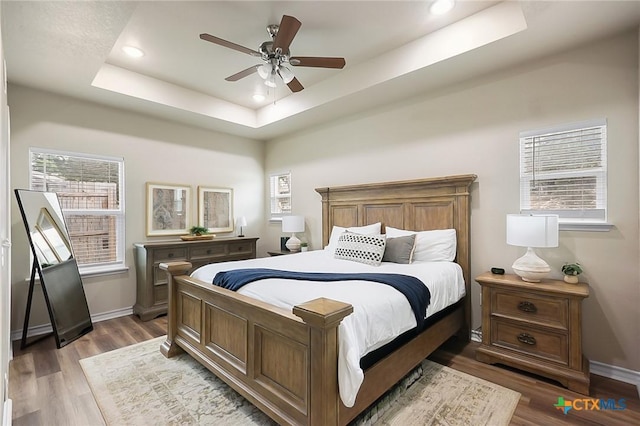 144 Slocum Dr, Canyon Lake, TX 78133 - bedroom with a raised ceiling, recessed lighting, wood finished floors, baseboards, and ceiling fan