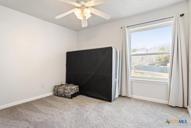 interior space with ceiling fan and carpet