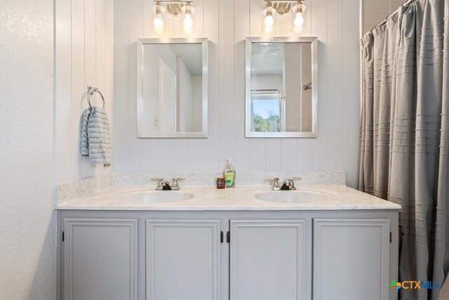 bathroom with double vanity and a sink