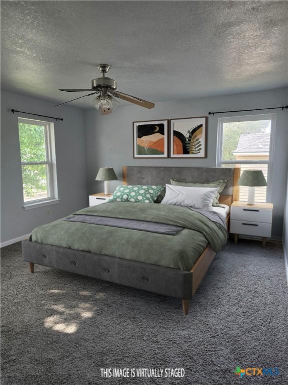 carpeted bedroom with multiple windows, a ceiling fan, and a textured ceiling