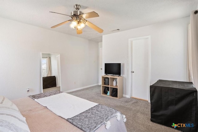 bedroom featuring light carpet, a textured ceiling, and ceiling fan