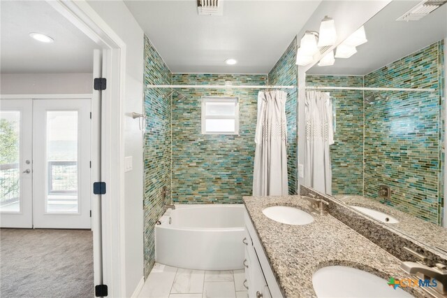 924 Kindersley St, Canyon Lake, TX 78133 - full bath with a bathtub, double vanity, a tile shower, and french doors