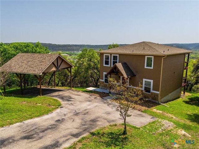 924 Kindersley St, Canyon Lake, TX 78133 - view of front of house featuring asphalt driveway, a front yard, a detached carport, covered porch, and stucco siding