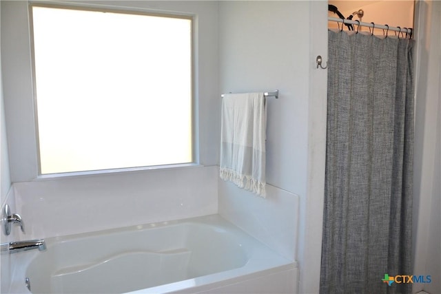 full bath with curtained shower and a bath