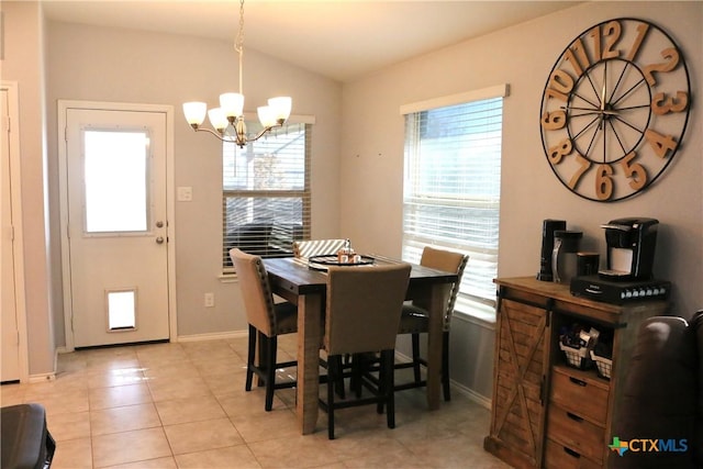 dining room featuring vaulted ceiling, a notable chandelier, light tile patterned flooring, and a wealth of natural light