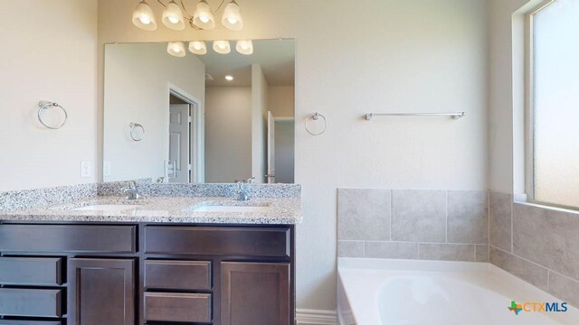 bathroom with vanity and a tub