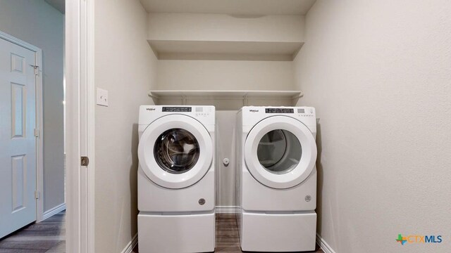 laundry area featuring separate washer and dryer and dark wood-type flooring