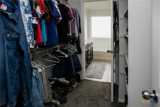 8915 Stonehollow Dr, Temple, TX 76502 - walk in closet featuring light tile patterned floors and light colored carpet