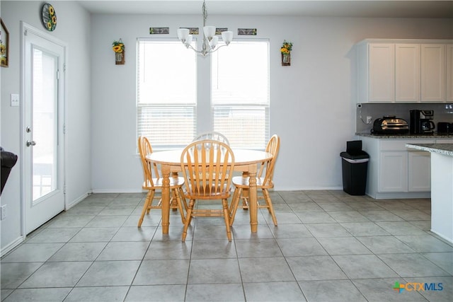 8915 Stonehollow Dr, Temple, TX 76502 - dining room featuring a chandelier, light tile patterned floors, and baseboards