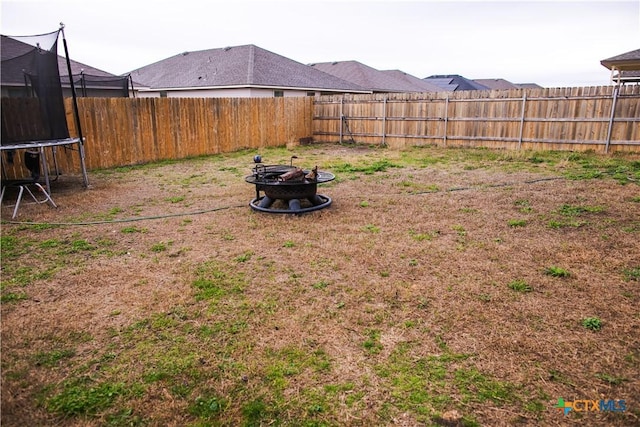 8915 Stonehollow Dr, Temple, TX 76502 - fenced backyard with a trampoline and a fire pit