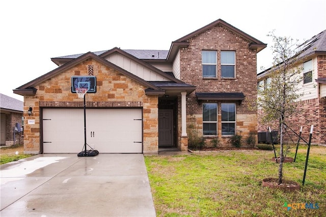 8915 Stonehollow Dr, Temple, TX 76502 - view of front facade with board and batten siding, stone siding, concrete driveway, a garage, and a front yard
