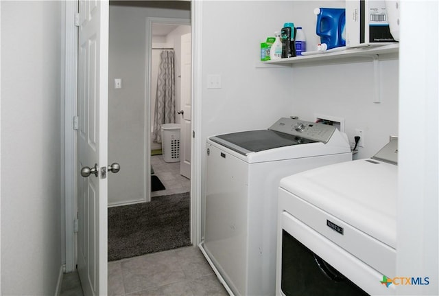 8915 Stonehollow Dr, Temple, TX 76502 - laundry area with washing machine and dryer and light tile patterned flooring