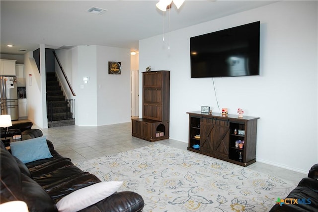 8915 Stonehollow Dr, Temple, TX 76502 - living area featuring stairway, light tile patterned flooring, and ceiling fan