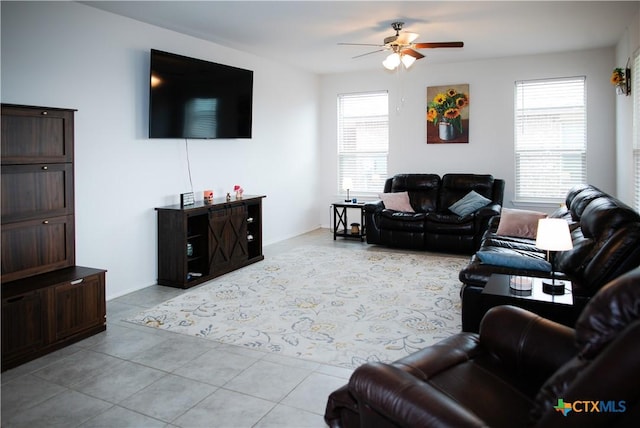 8915 Stonehollow Dr, Temple, TX 76502 - living area featuring ceiling fan, light tile patterned flooring, and baseboards