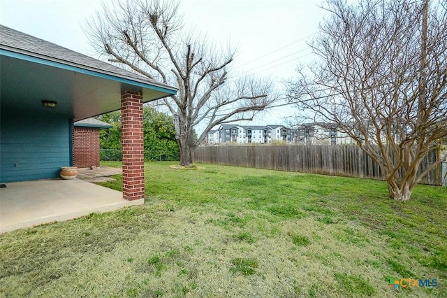 view of yard featuring fence and a patio