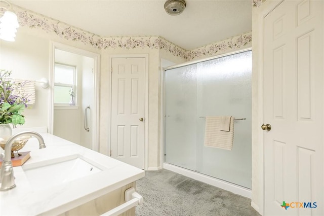 bathroom featuring a sink and a shower stall