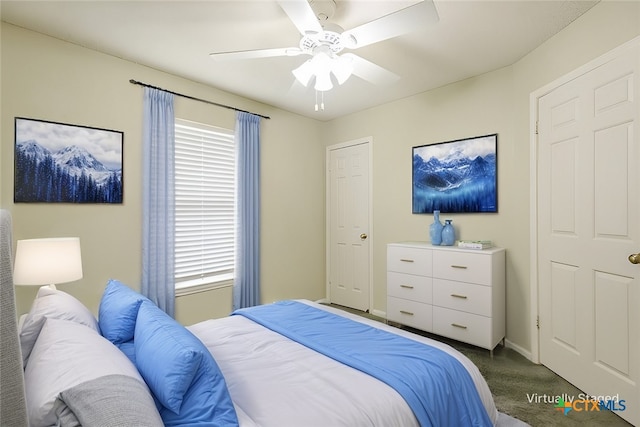 bedroom featuring ceiling fan, dark colored carpet, and baseboards