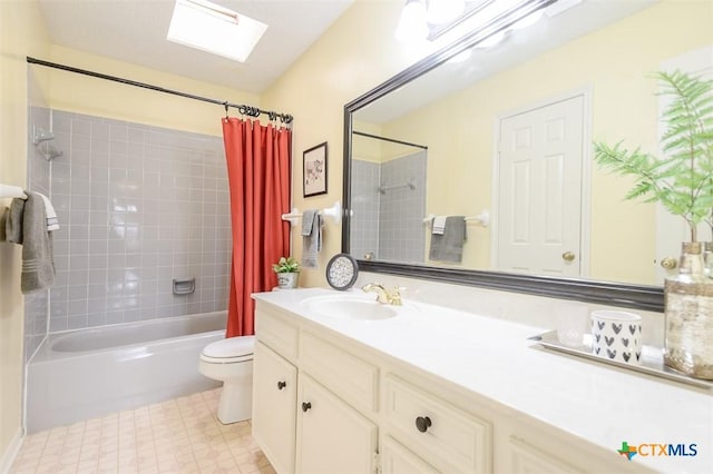 bathroom with a skylight, vanity, toilet, and shower / bath combo with shower curtain