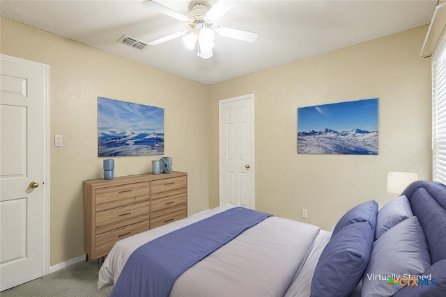 bedroom with baseboards, visible vents, ceiling fan, and carpet flooring