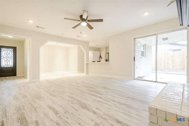 unfurnished living room featuring light hardwood / wood-style floors and ceiling fan