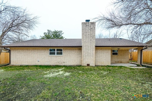 back of house with a patio and a lawn