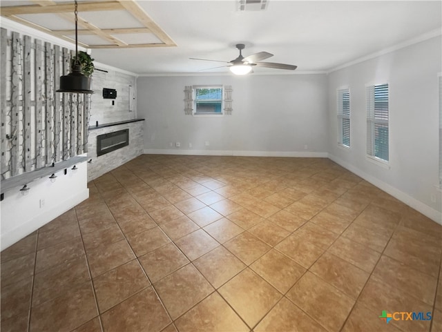 unfurnished living room featuring ceiling fan, tile patterned floors, and ornamental molding