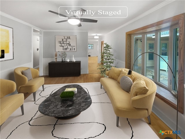 living room with ceiling fan, light wood-type flooring, and ornamental molding