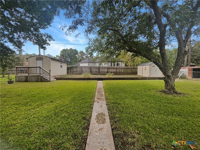 view of yard with an outdoor structure and a wooden deck