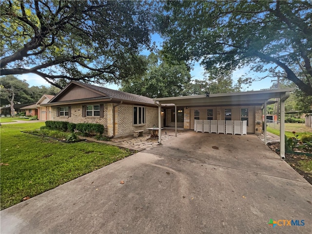 single story home with a front yard and a carport