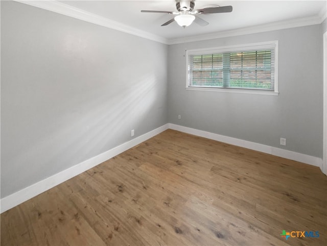 empty room with ceiling fan, hardwood / wood-style flooring, and ornamental molding