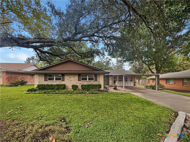 ranch-style home with a front yard and a carport