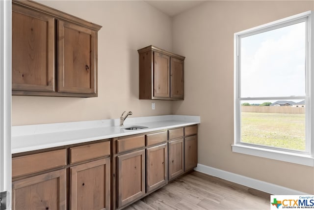 kitchen with light wood-type flooring and sink