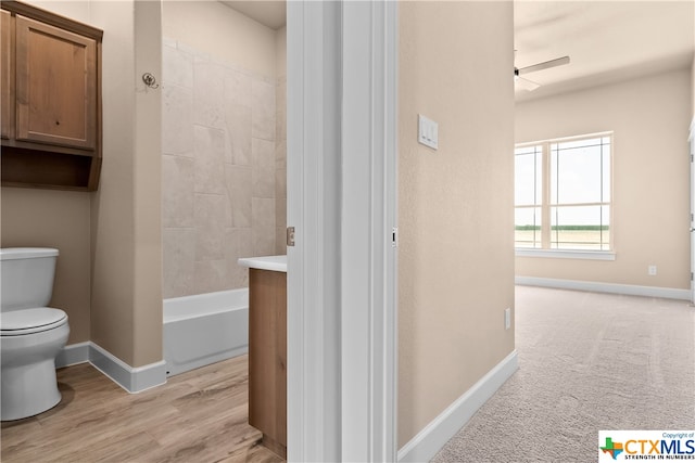 bathroom featuring wood-type flooring and toilet