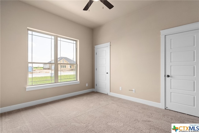 unfurnished bedroom with light colored carpet and ceiling fan