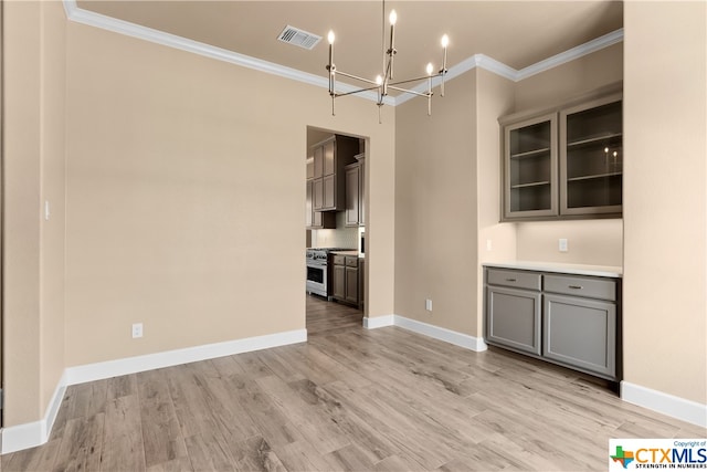 unfurnished dining area with light wood-type flooring and ornamental molding