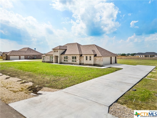 view of front of house with a garage and a front yard