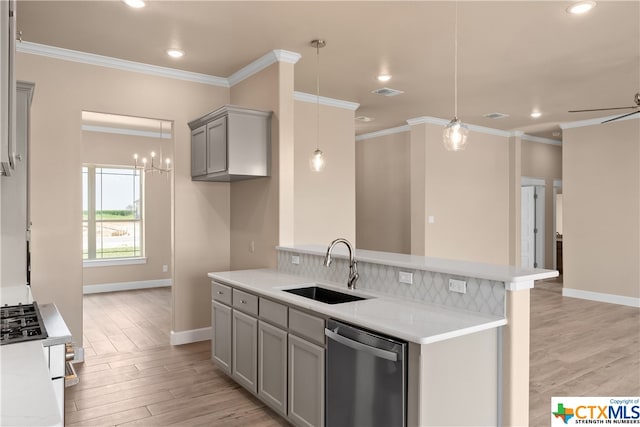 kitchen featuring stainless steel appliances, light stone counters, sink, gray cabinets, and light hardwood / wood-style flooring