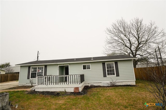 rear view of property with a wooden deck and a yard