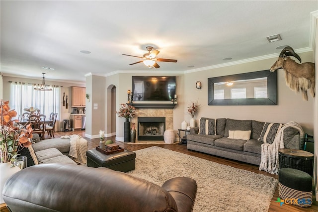 312 Ow Lowrey Dr, Salado, TX 76571 - living room featuring wood finished floors, a chandelier, ceiling fan, a tile fireplace, and crown molding